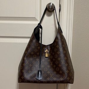 Like new Louis Vuitton flower handbag with black detail.